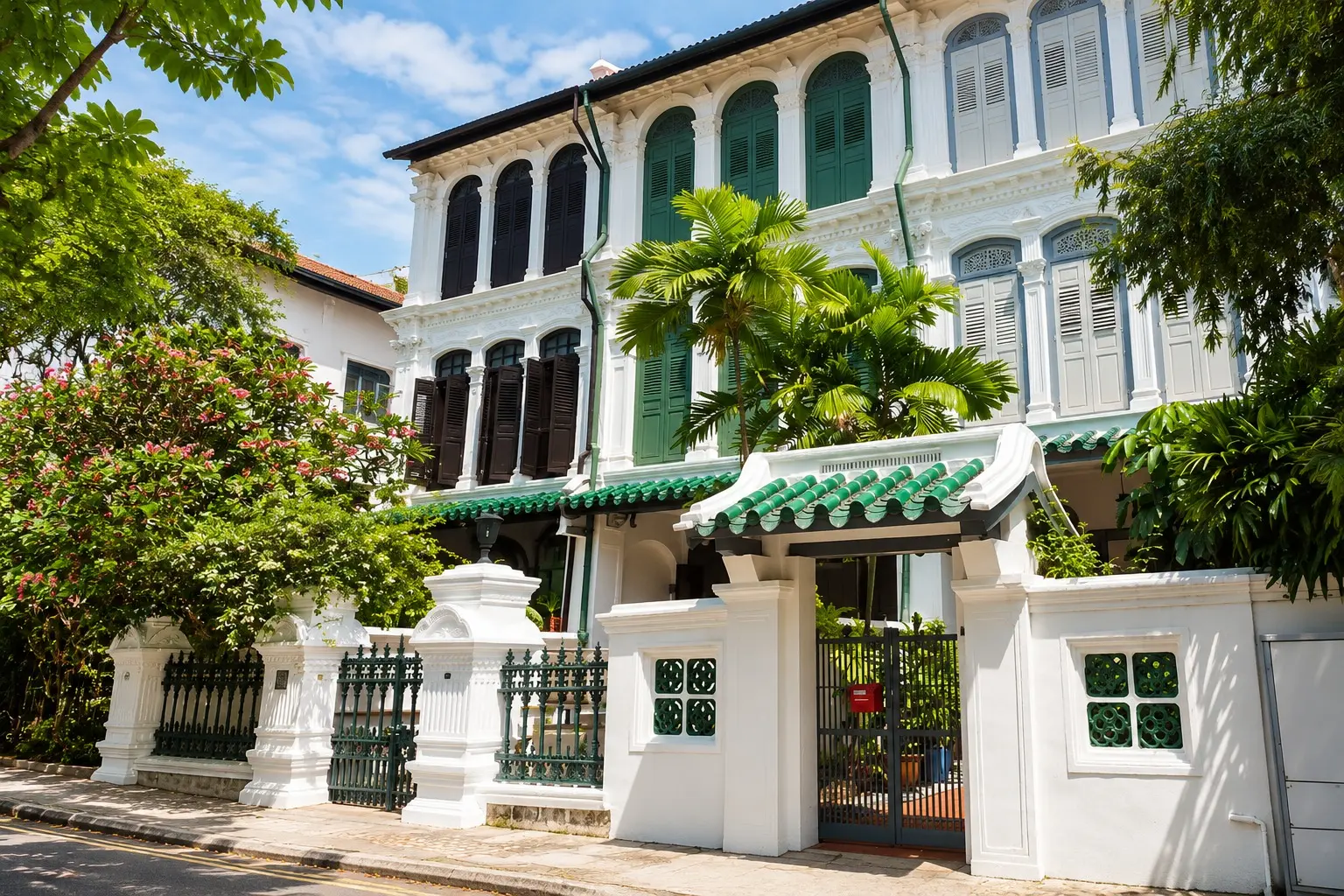 Restored colonial-style landed property in Singapore with green shutters and a walled garden entrance